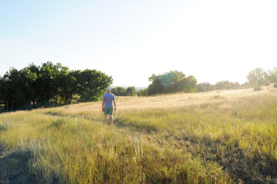 Man walking on trail on the QuietWaters retreat center grounds