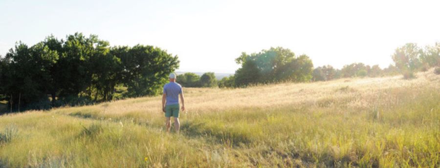 Man walking on a trail at the QuietWaters retreat center